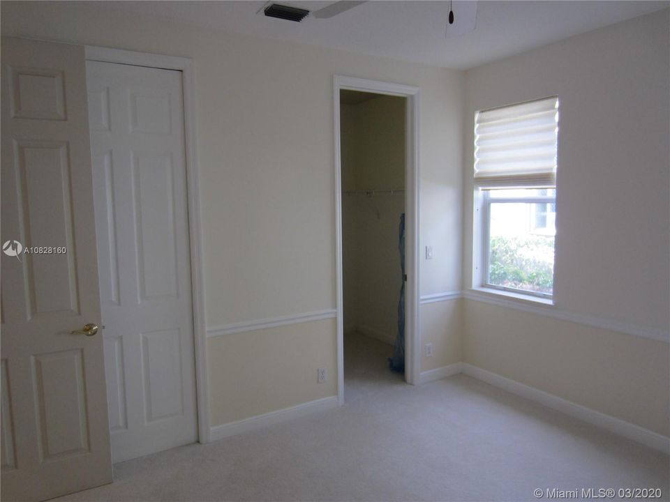 BEDROOM 2 WITH WALK IN CLOSET AND BATH.
