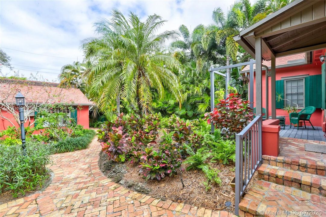 Deck on Back of main house, paved walkway to pool & Guest House