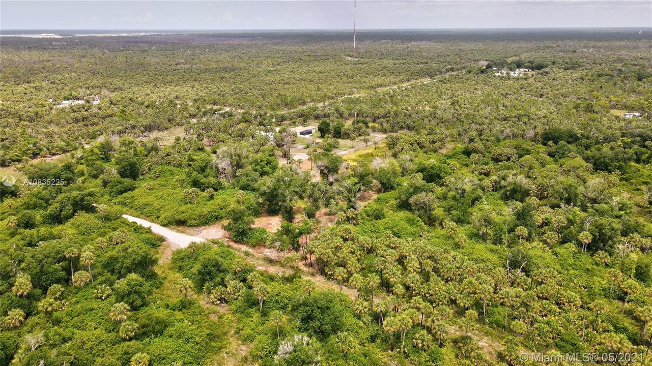 Entry road to property in foreground looking Northwest toward Benton Rd near tower
