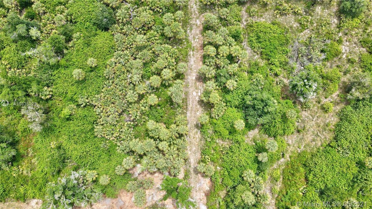 Aerial view of property looking east with entry in lower left area of photo