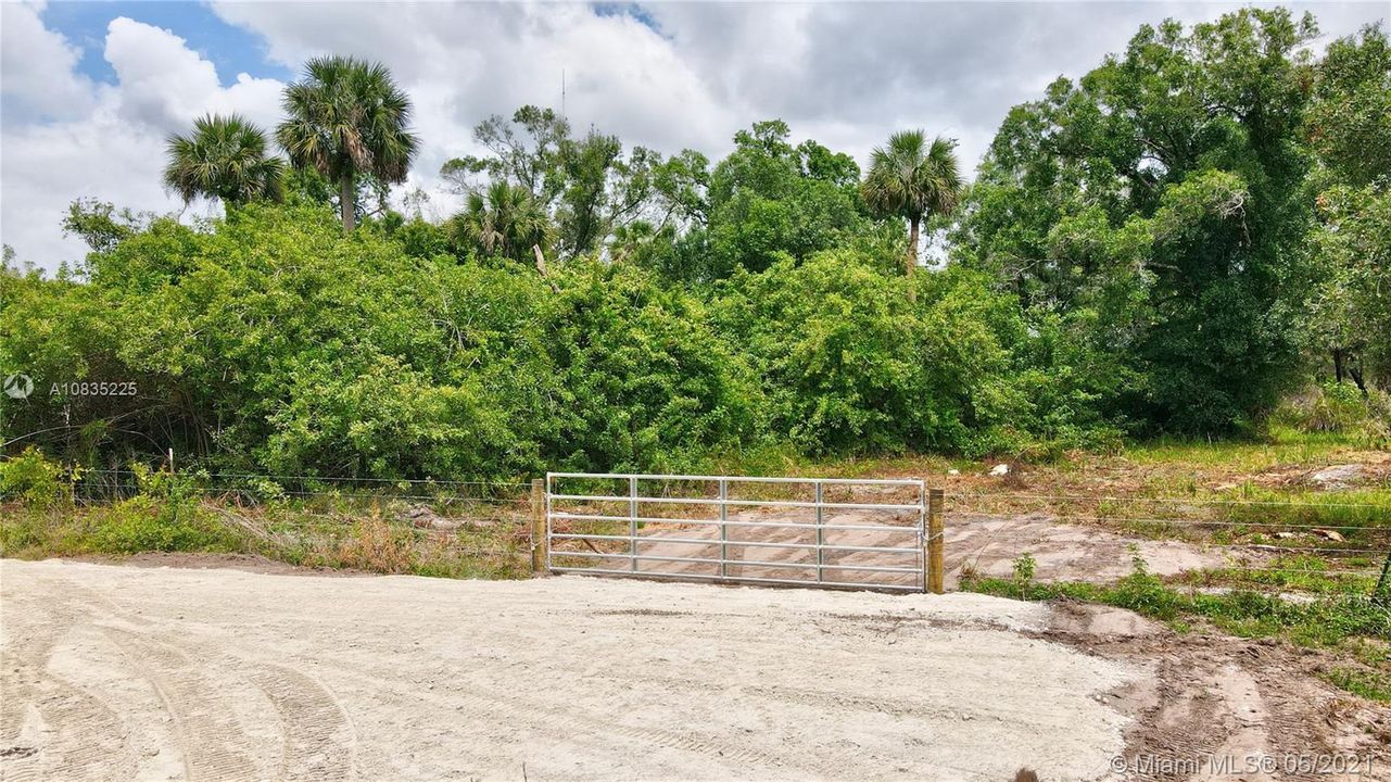 Entry gate and fence to this 5-acre parcel