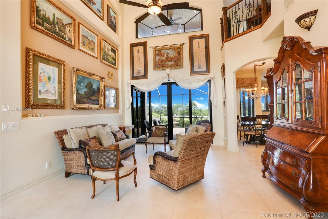 Living room overlooking terrace and golf course and glimpses of Intracoastal