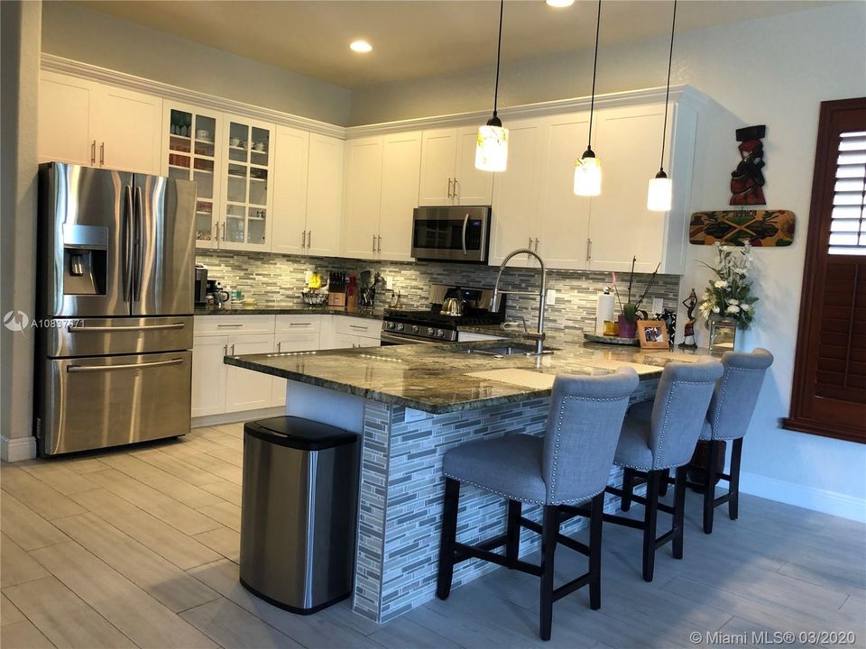 Remodeled kitchen with brand new SS appliances. New Marble counters and cabinets and custom lighting.