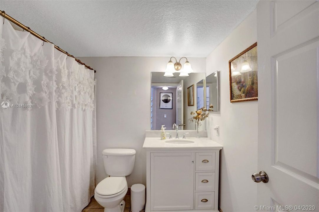Guest Bathroom remodeled with newer vanity top and mirror.