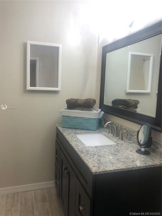 Master bathroom vanity, granite top and framed mirror
