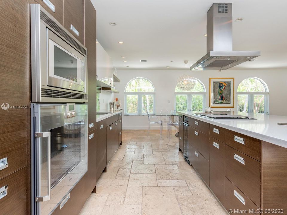 Gaggenau built in microwave and oven and custom cabinetry surround this modern kitchen