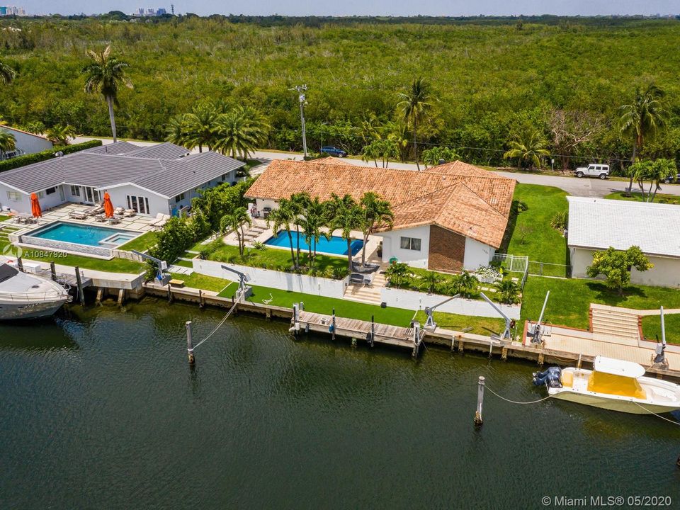 Aerial view of home with waterfront dock and outdoor living areas