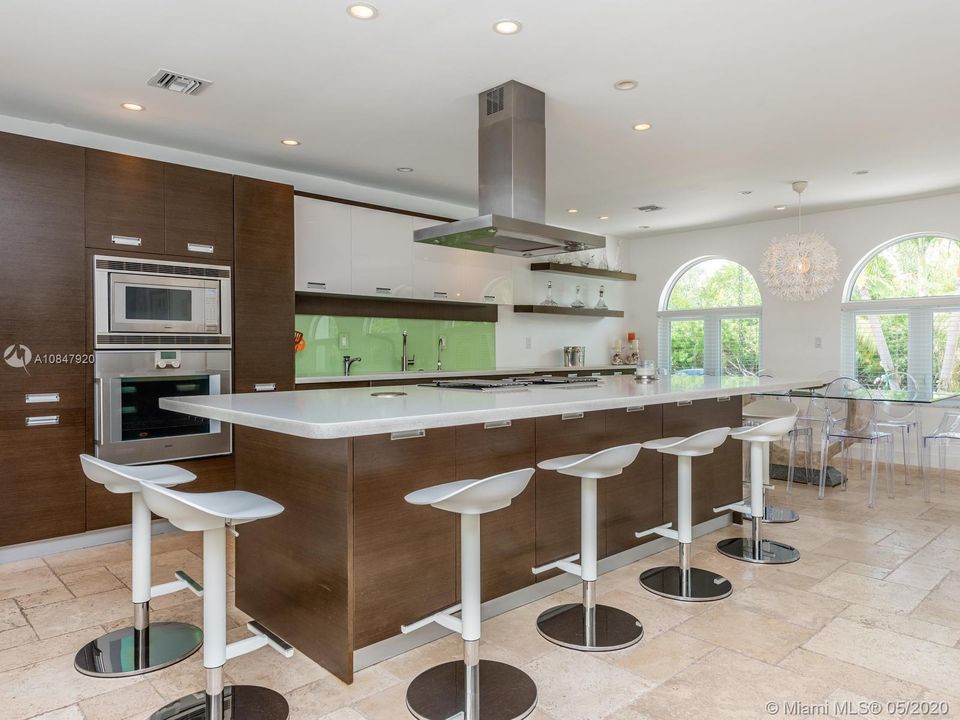 Large quartz center island with induction cooktop and vent