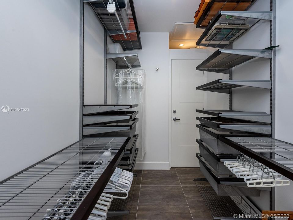 Spacious master closet with organized storage