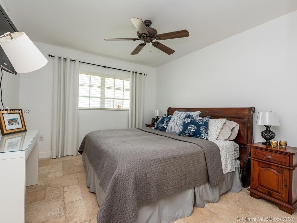 Bedroom with travertine floors