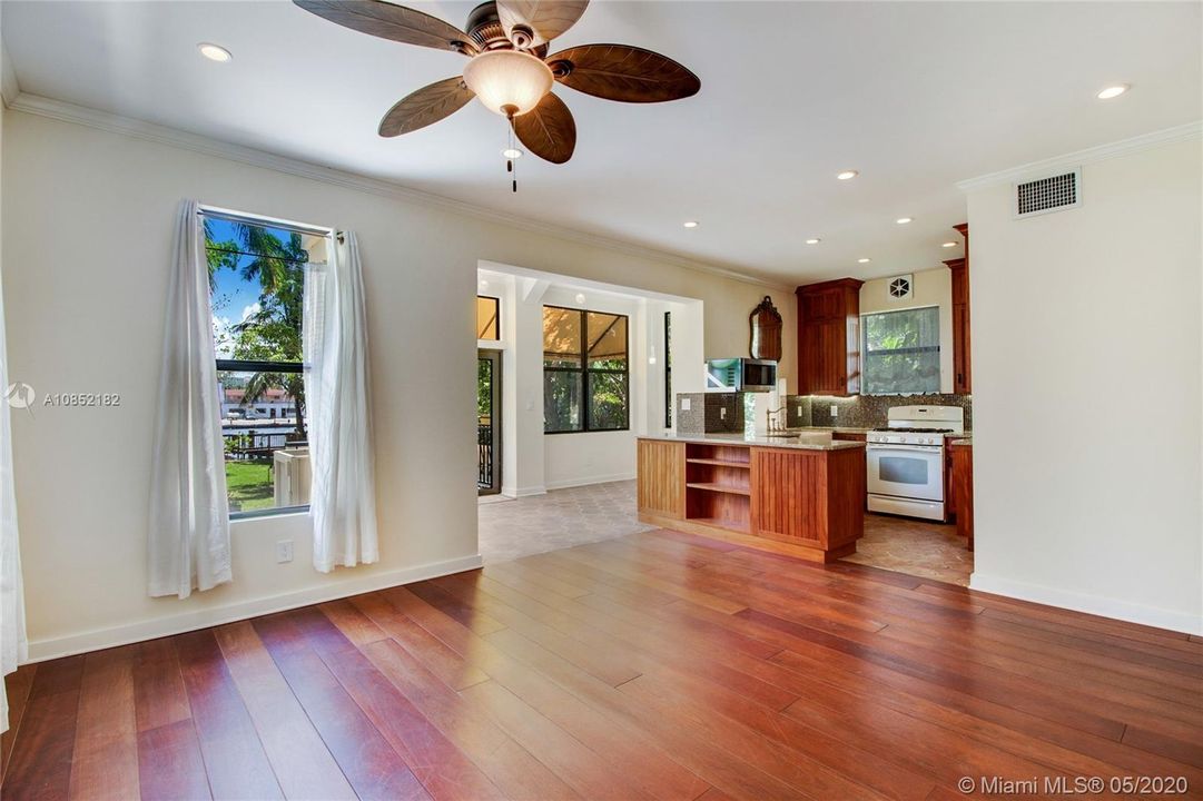 Family Room in foreground and Back Room (breakfast area) and Kitchen.