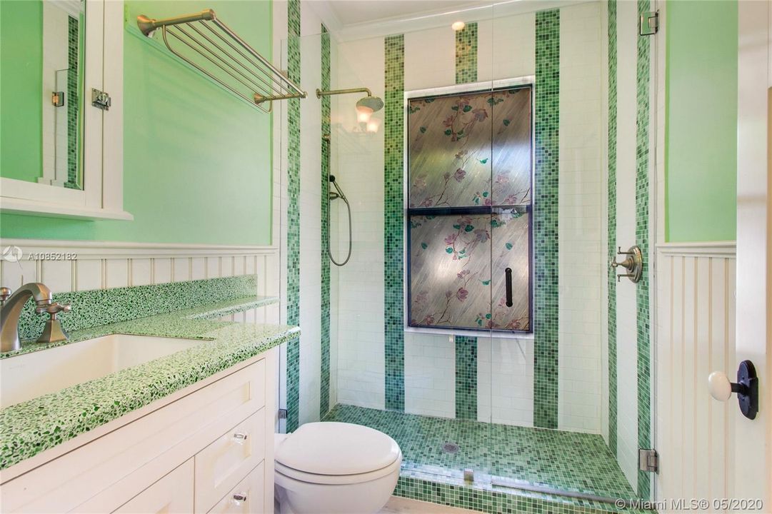 Hall bath graciously updated in keeping with the original splendor of the home.