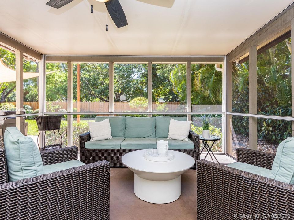 Large screened-in porch overlooking the sprawling and private backyard.