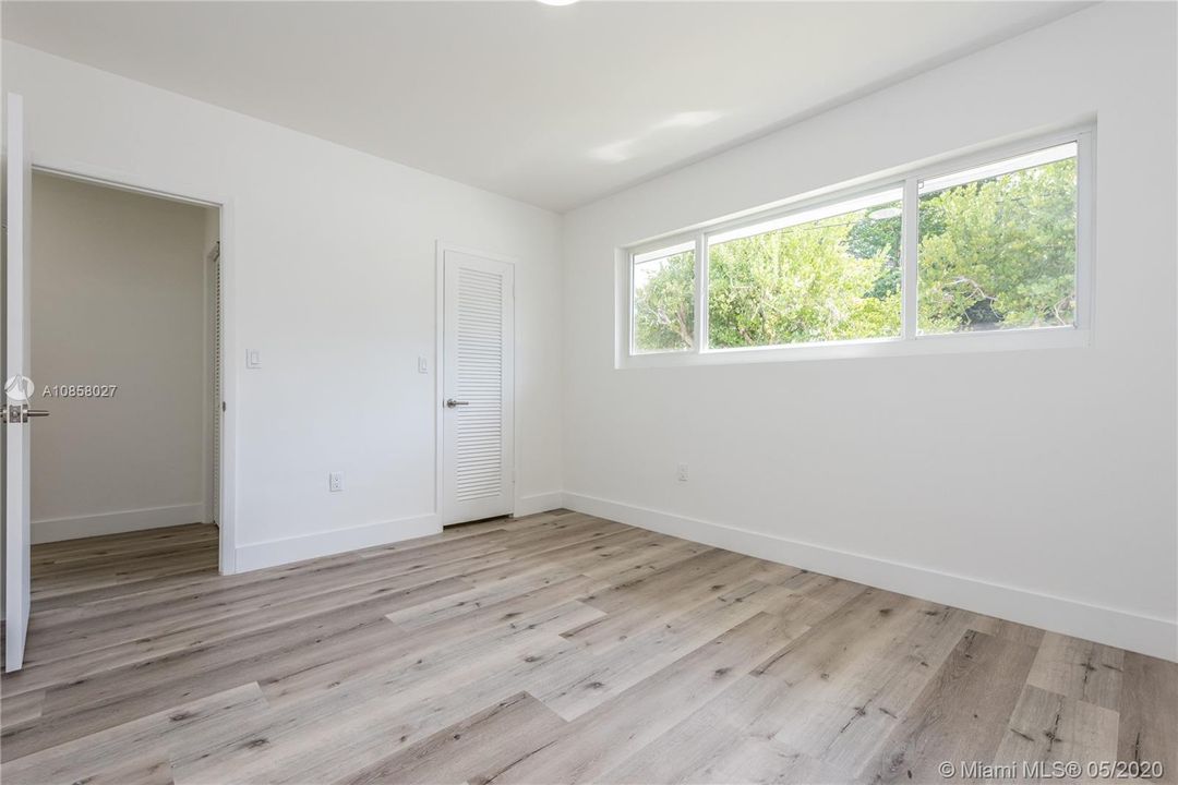 Additional family bedroom. Bimini grey vinyl-wood floors and transom windows.