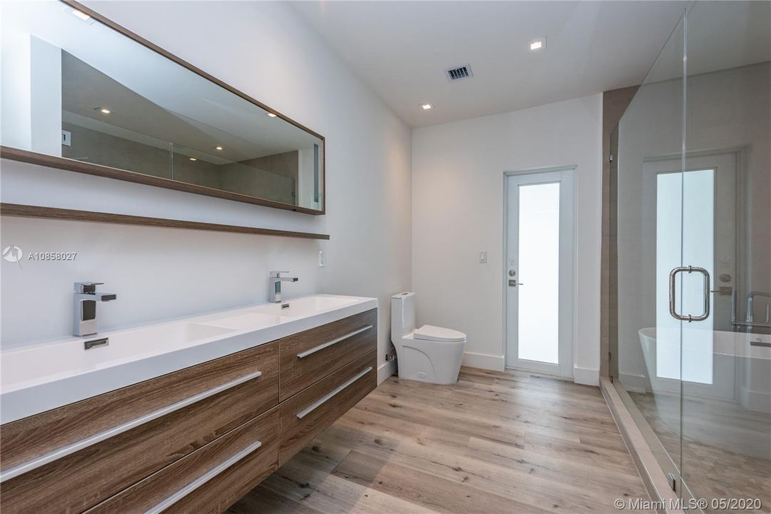 Master bathroom with dual sinks. Freestanding tub inside enormous shower room.