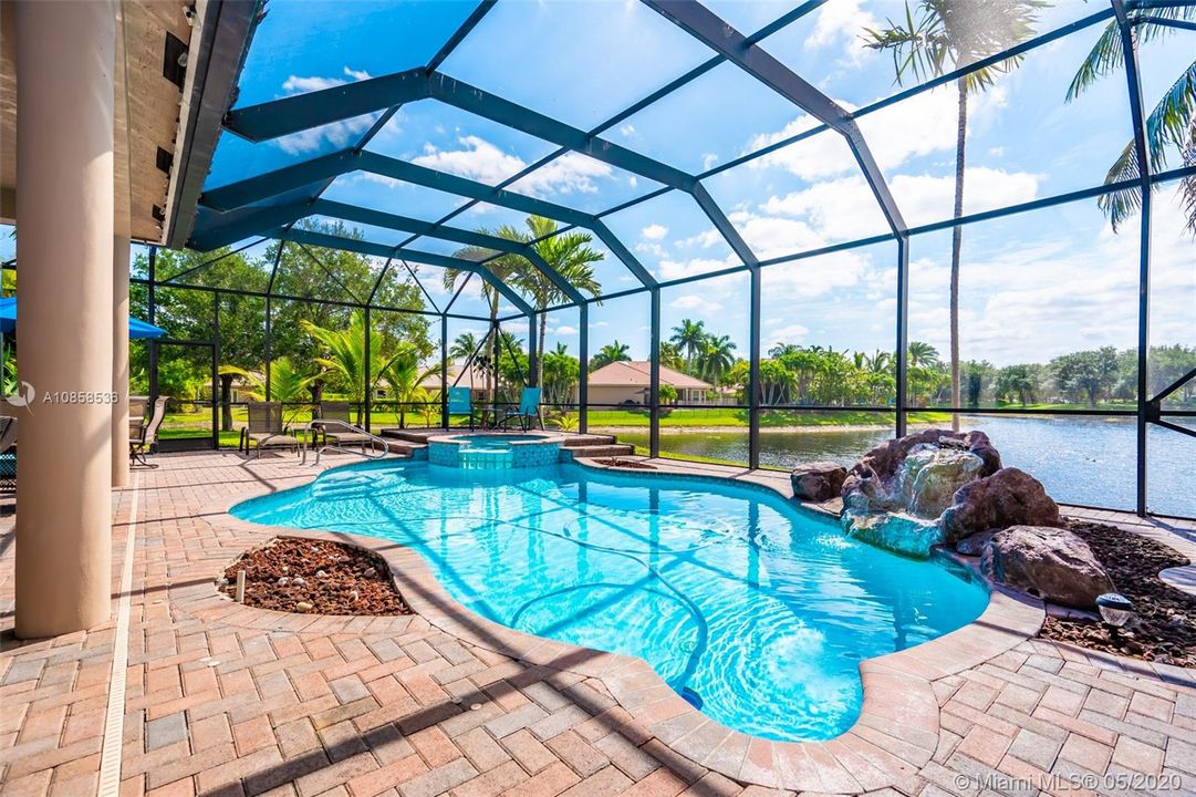 Heated Pool with Spa on Screened patio with gorgeous long Lake view