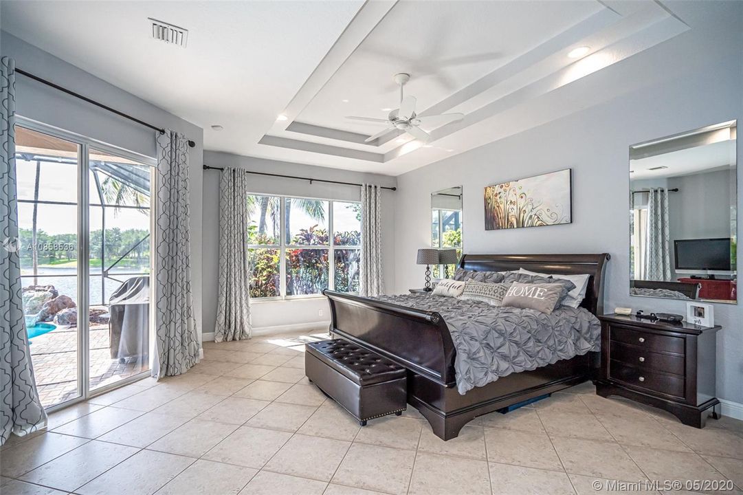 Master bedroom with sliding glass door open to pool