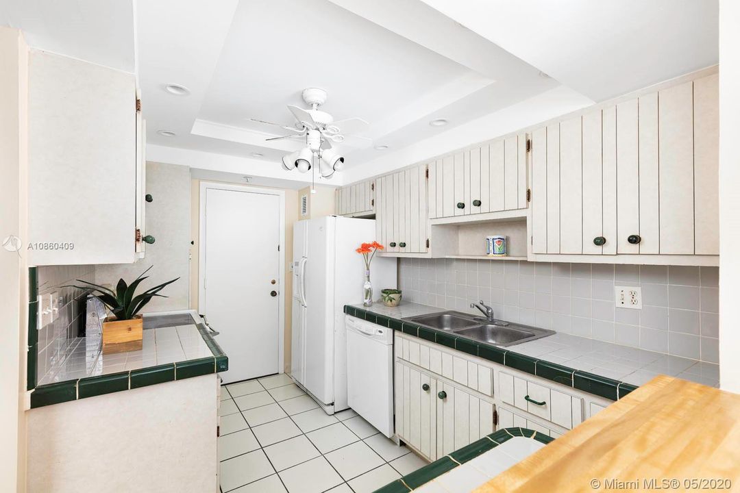 Kitchen configuration opens to living and dining rooms.