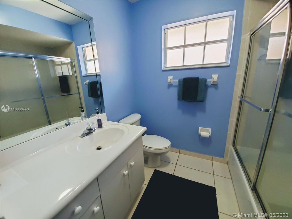 Guest Bathroom with combination bathtub and shower.  Also has window for natural light.