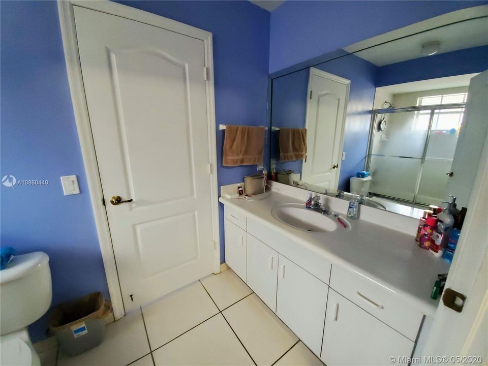 Jack & Jill shared bathroom. Combination shower and tub. Window with natural light.