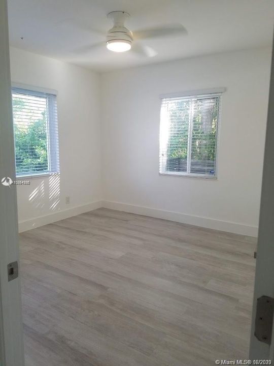 Both bedrooms boast corner windows and fill the rooms with natural light