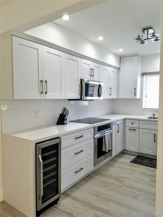 Custom kitchen with lots of storage and Stainless Steel appliances