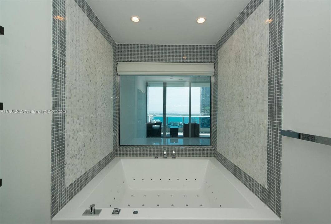 Master Bathroom: Upgraded KOS 72” x 60” tub with special lighting, Italian imported mosaic and imported Zuchetti faucets and fixtures. The glass window gives a special touch to this outstanding bathroom.