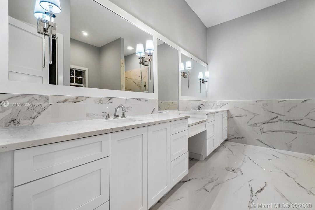 Master bathroom with vanity area, large shower & separate tub, and water closet