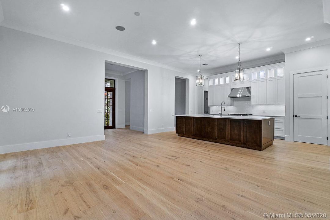 View from great room to kitchen and foyer entry.