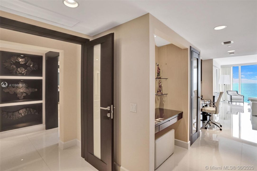 Master bedroom with double doors and office space.
