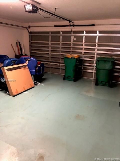 garage with opener and storm rated door