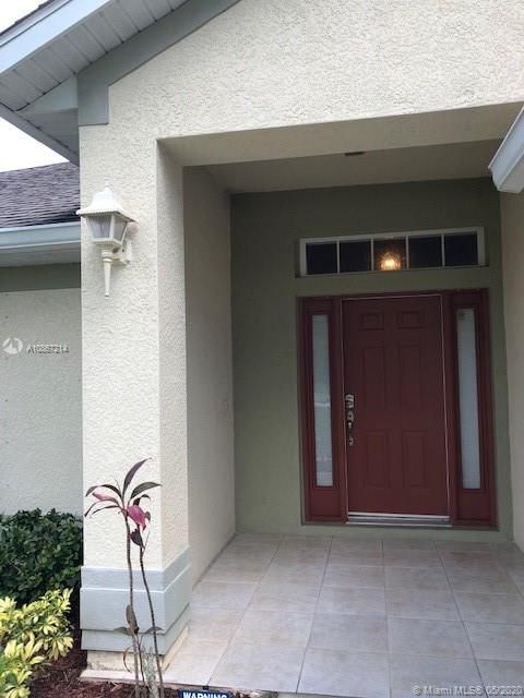 inviting entrance with sidelights at door and transom window over door