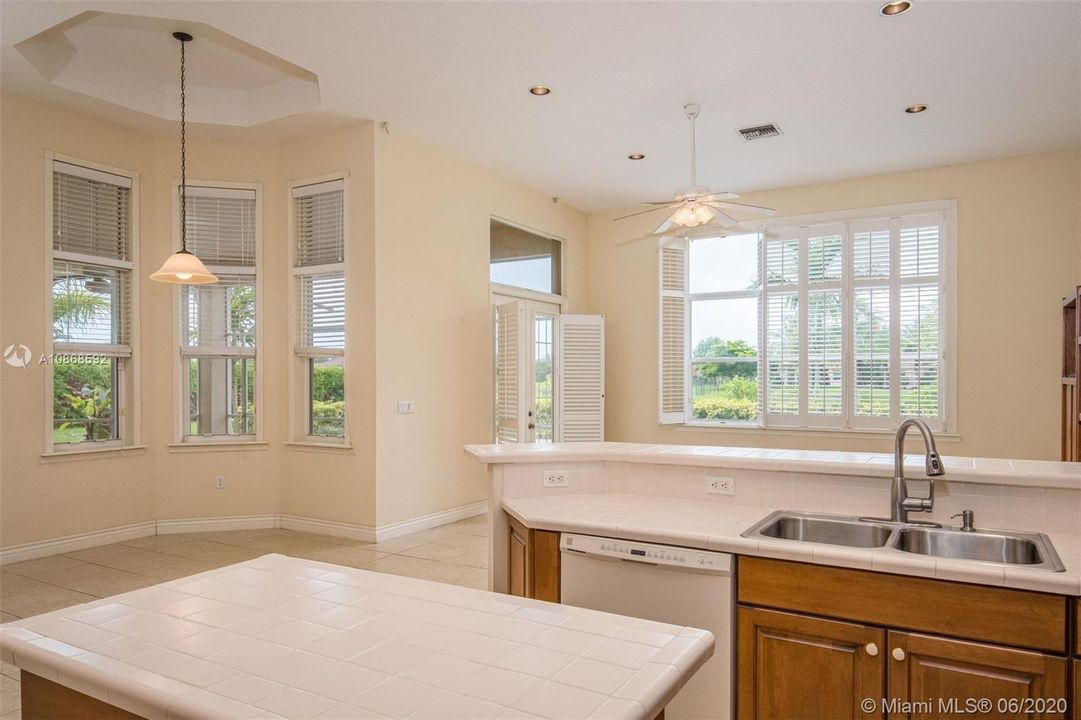 Views to breakfast nook and family room from kitchen
