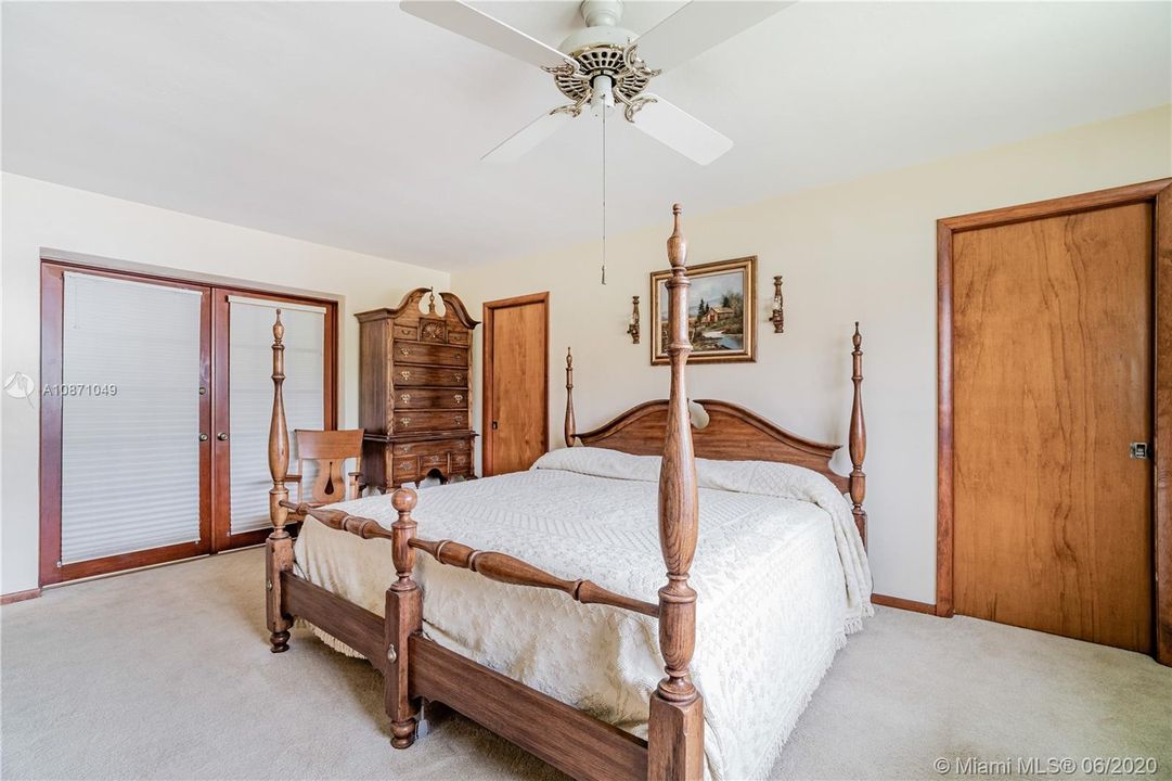 Master bedroom with french doors leading to the family room and XL walk-in closet
