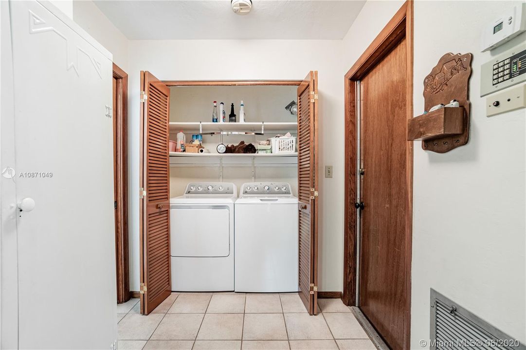 Inside laundry room next to door to 2 car garage
