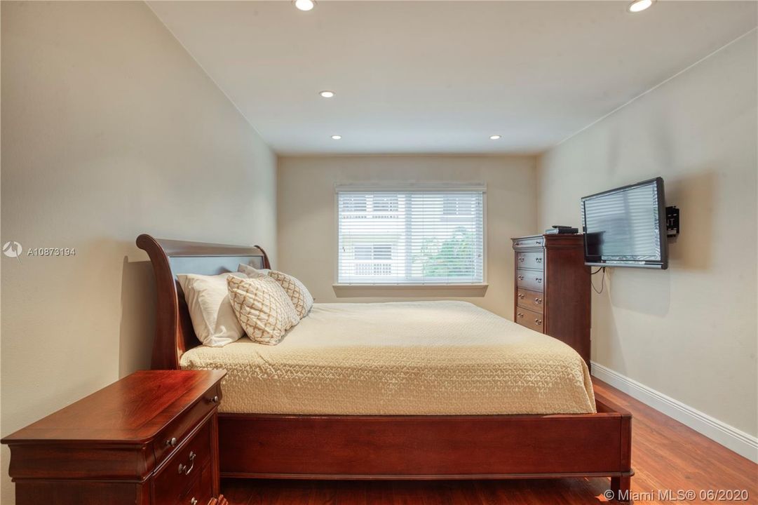 Bedroom - includes wood sleigh bed, bed side table, chest of drawers and mounted 42 flat screen TV