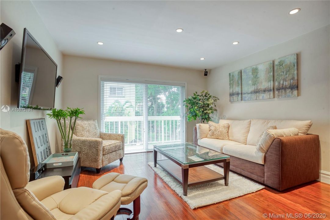 Living Room - includes neutral leather & fabric furnishings, area rug and art