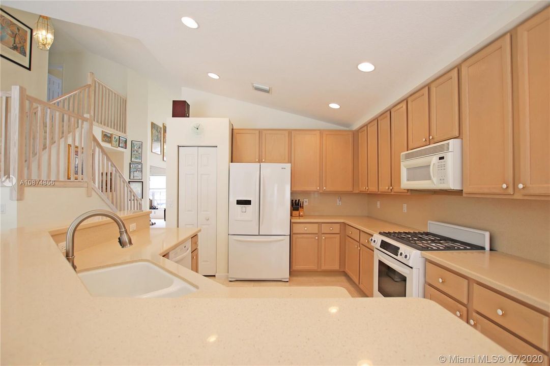 Kitchen with quartz counters & natural gas stove/oven