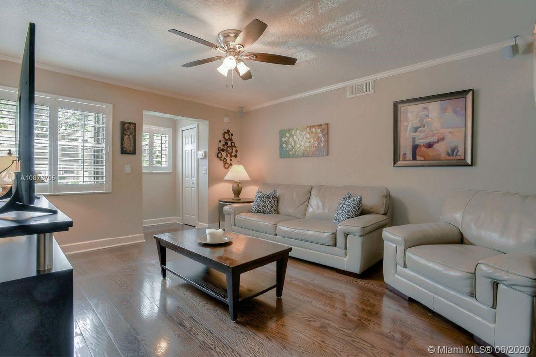 Living Room with Plantation Shutters and wood floor