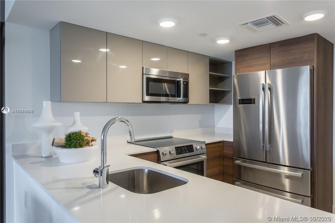 This is a kitchen from another unit, unit 305 kitchen has similar finishes.