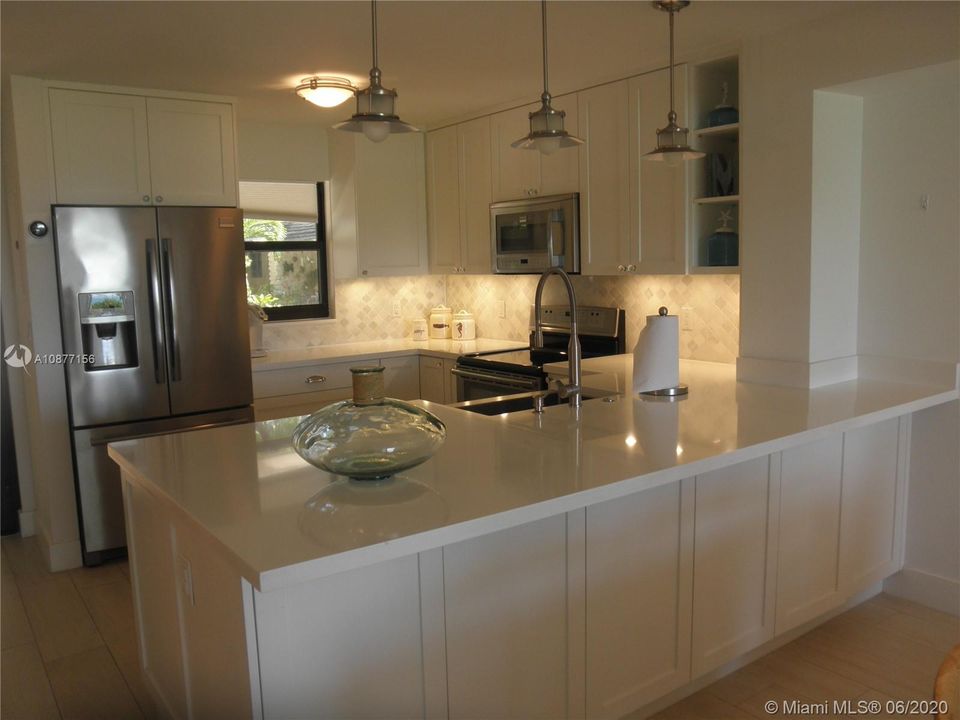 VIEW OF THE KITCHEN FROM THE DINING ROOM