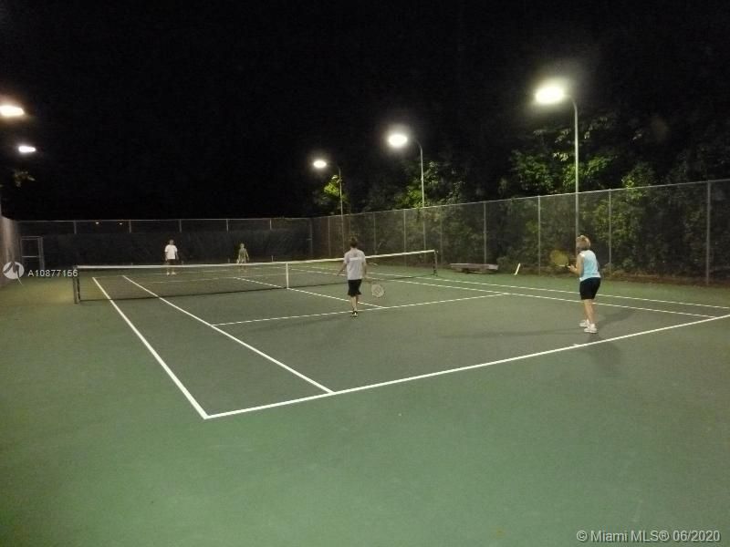 ONE OF VARIOUS LIGHTED TENNIS COURTS LOCATED INSIDE THE COMMUNITY