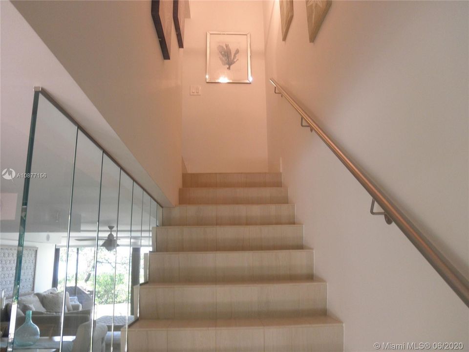 TILED STAIRS THAT TAKE YOU TO THE SECOND FLOOR OF THE TOWNHOUSE