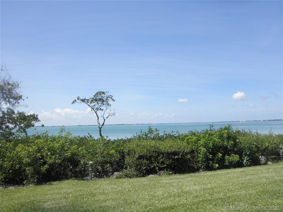 VIEW FROM INSIDE THE TOWNHOUSE OF THE BACK GRASSY AREAAND BEAUTIFUL BAY VIEW