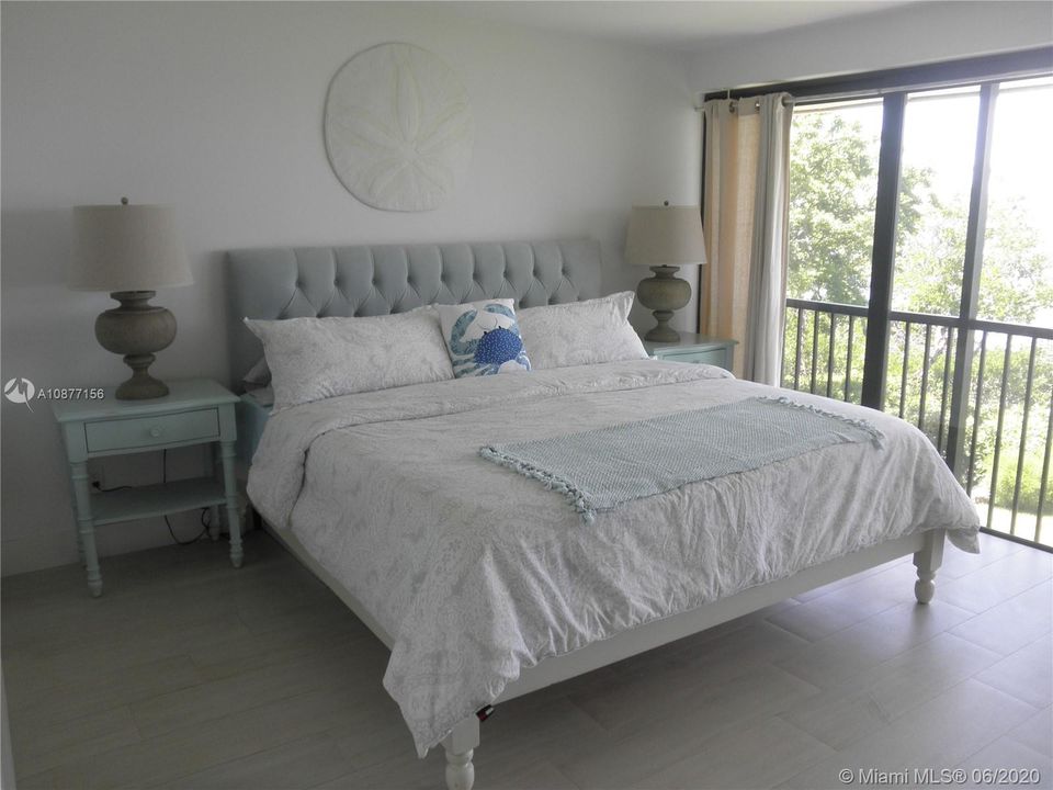 MASTER BEDROOM WITH KING SIZE BED AND VIEW OF BAY