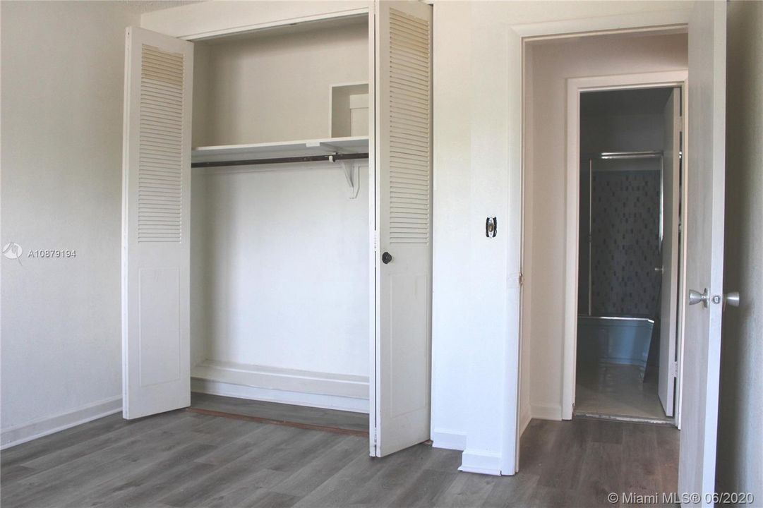 The wide closet provides plenty of space.  Directly across from the bedroom door is the bathroom.