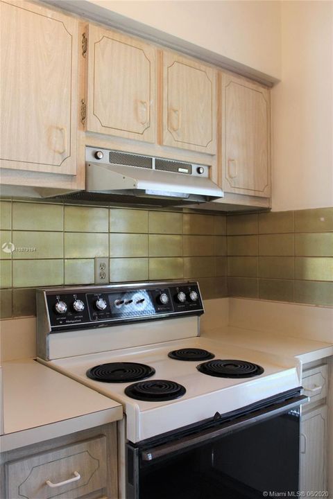 electric range with counter space on each side to help while cooking.