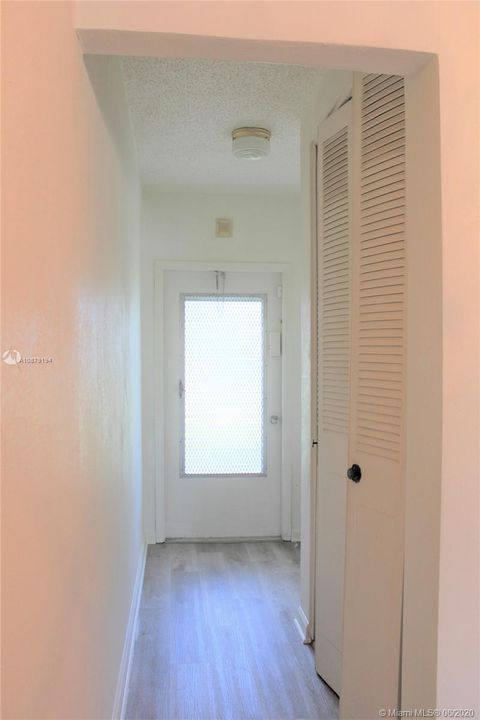 The 2nd front entrance door and another storage closet on the right of the hallway.