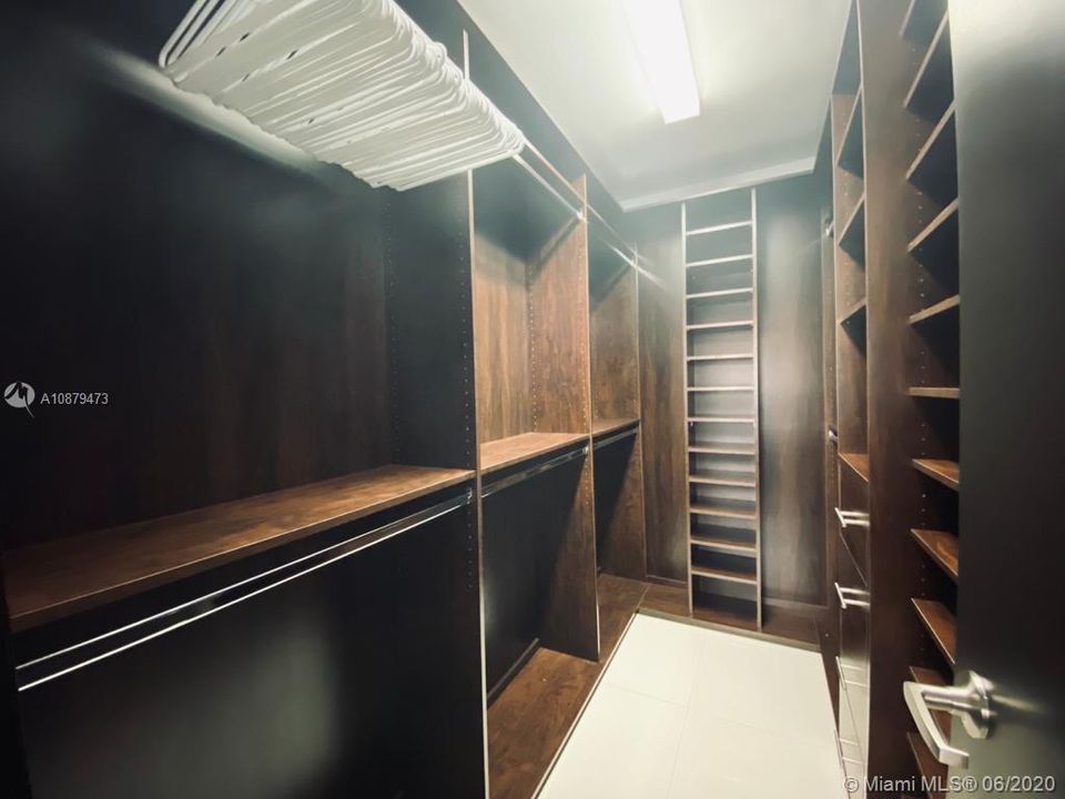 fourth bedroom with wall-to-wall built-in closet.