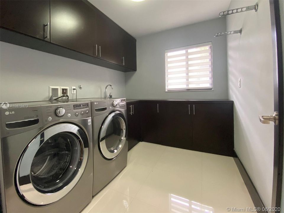 Spacious laundry room with built-in cabinets.